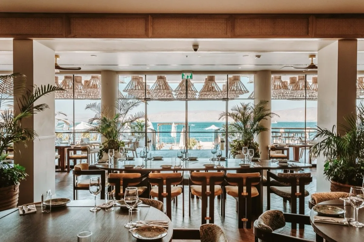 The dining room looks out at its own palms.